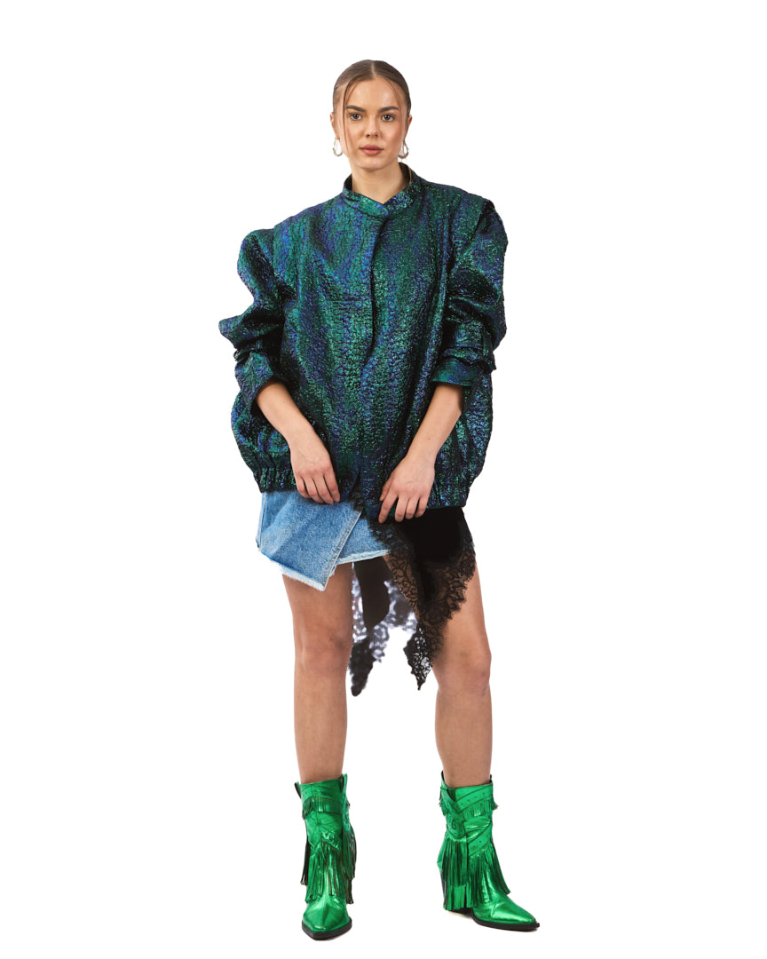 A bold iridescent jacket featuring a striking blend of deep emerald, teal