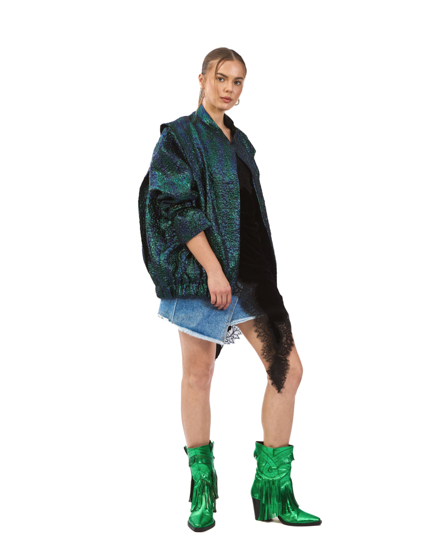 A bold iridescent jacket featuring a striking blend of deep emerald, teal