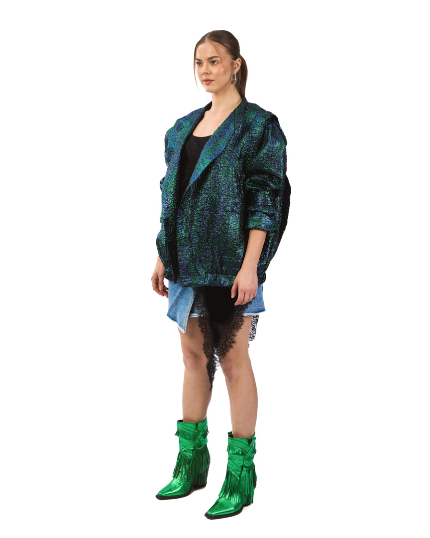 A bold iridescent jacket featuring a striking blend of deep emerald, teal