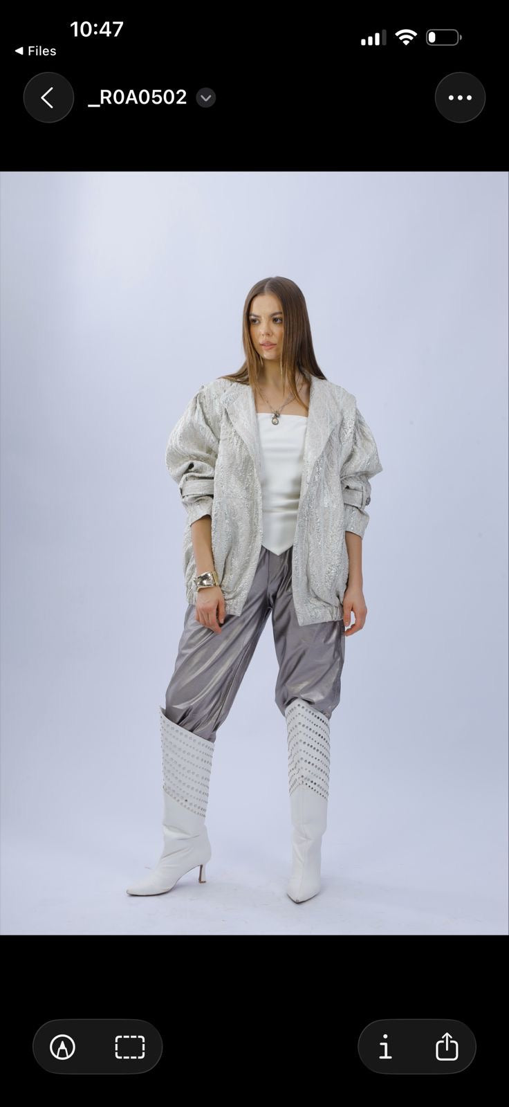 A soft champagne-beige textured jacket with a subtle luminous finish