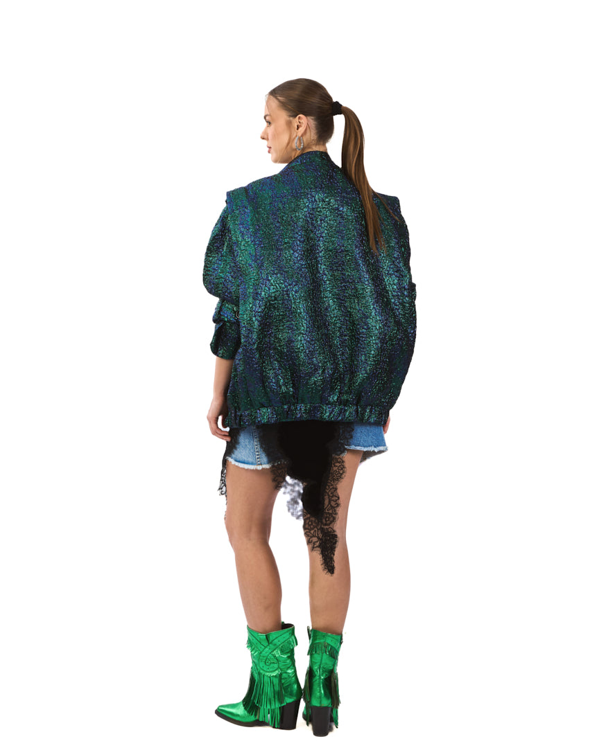 A bold iridescent jacket featuring a striking blend of deep emerald, teal